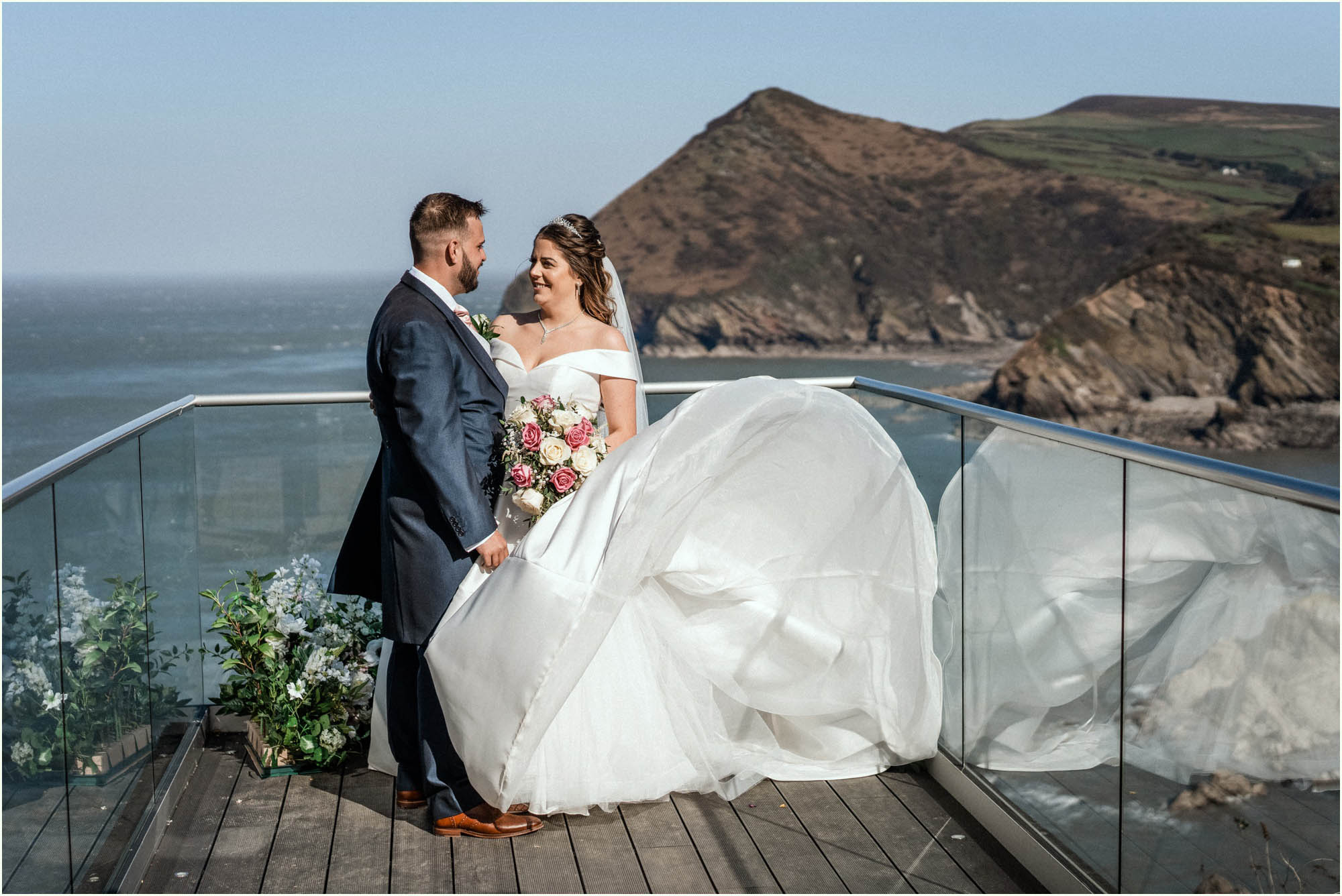 Adam and Abbie's Sandy Cove wedding in Devon with an outdoor ceremony and elegant summer styling in ivory and blush