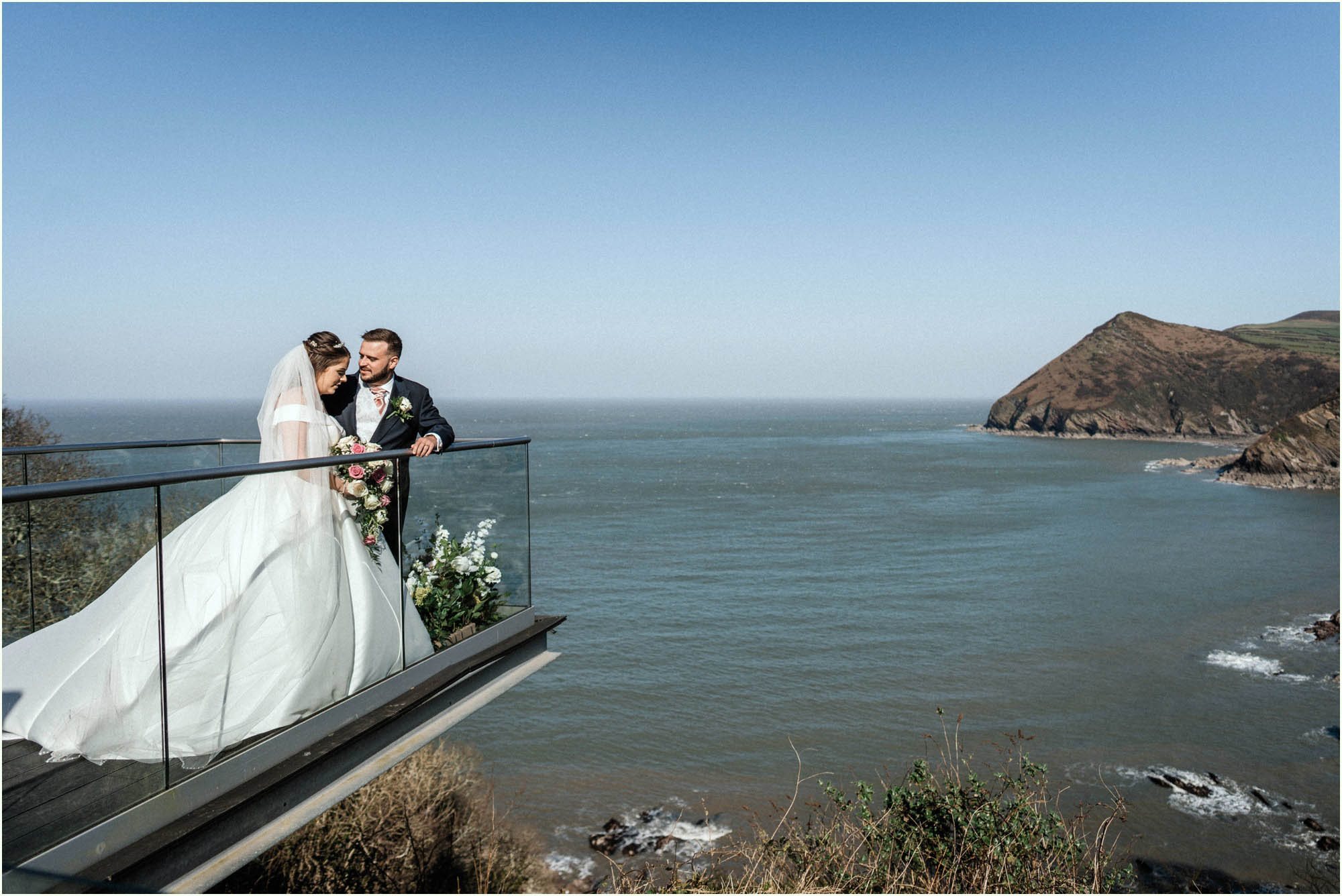 Adam and Abbie's Sandy Cove wedding in Devon with an outdoor ceremony and elegant summer styling in ivory and blush