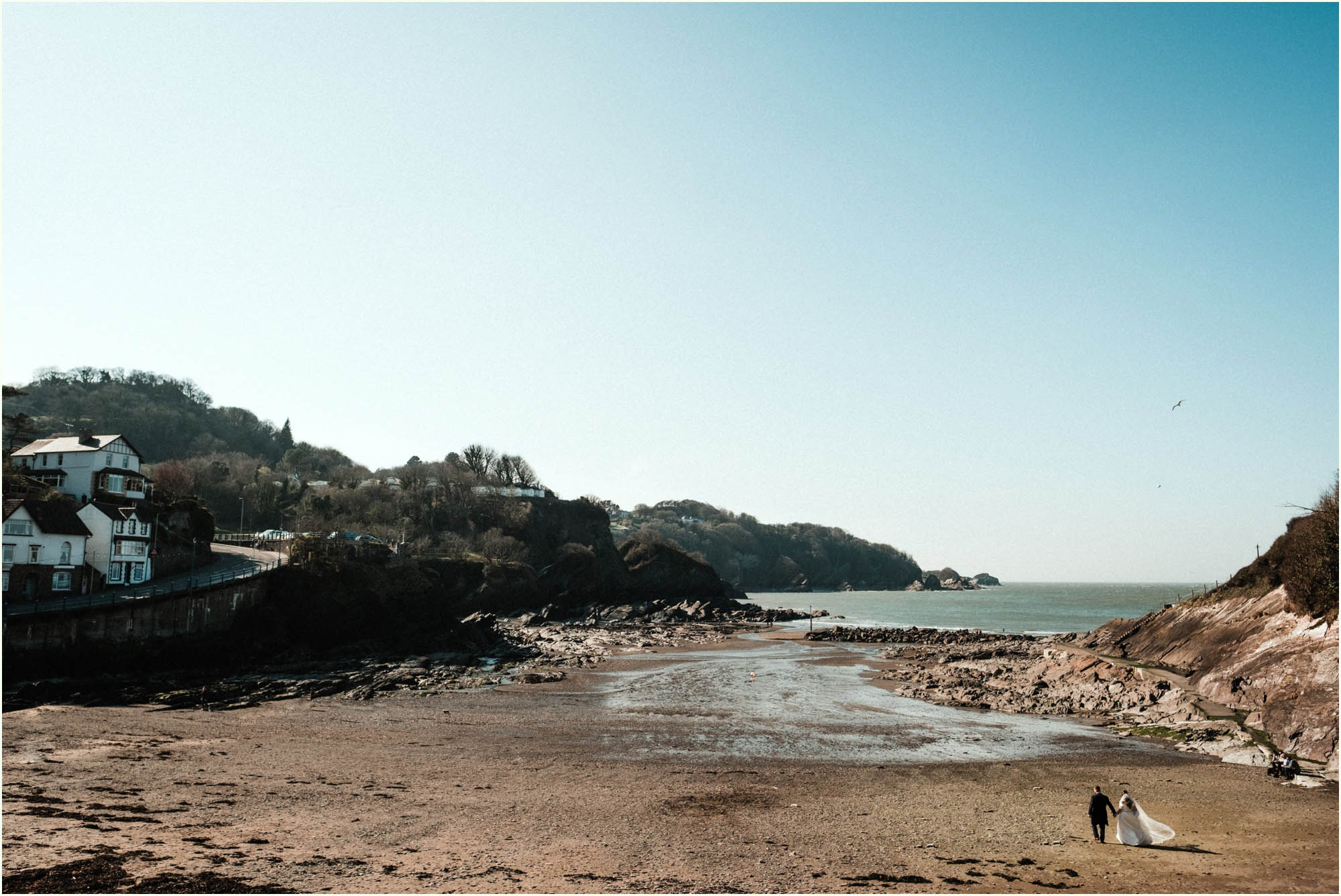 Adam and Abbie's Sandy Cove wedding in Devon with an outdoor ceremony and elegant summer styling in ivory and blush