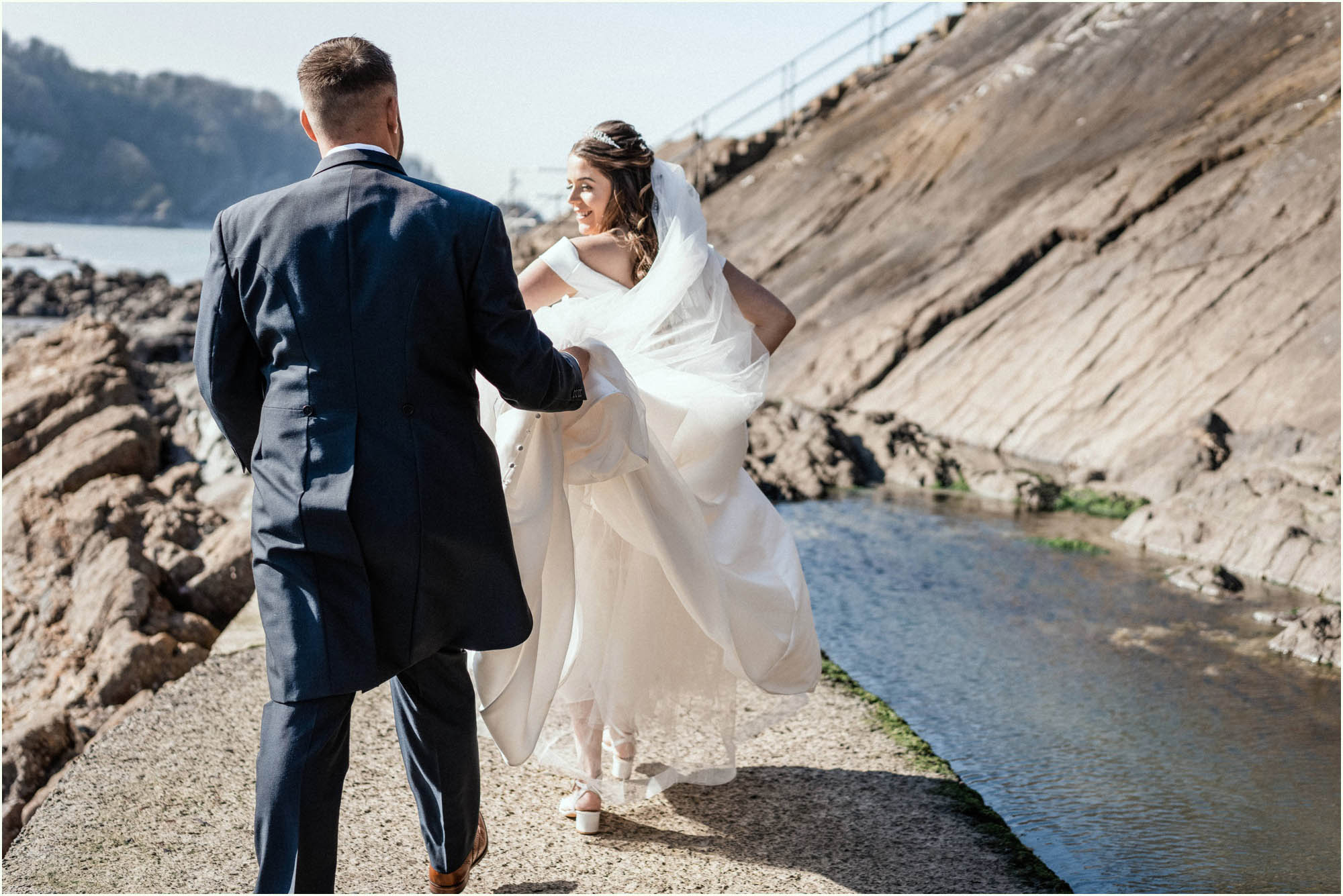 Adam and Abbie's Sandy Cove wedding in Devon with an outdoor ceremony and elegant summer styling in ivory and blush