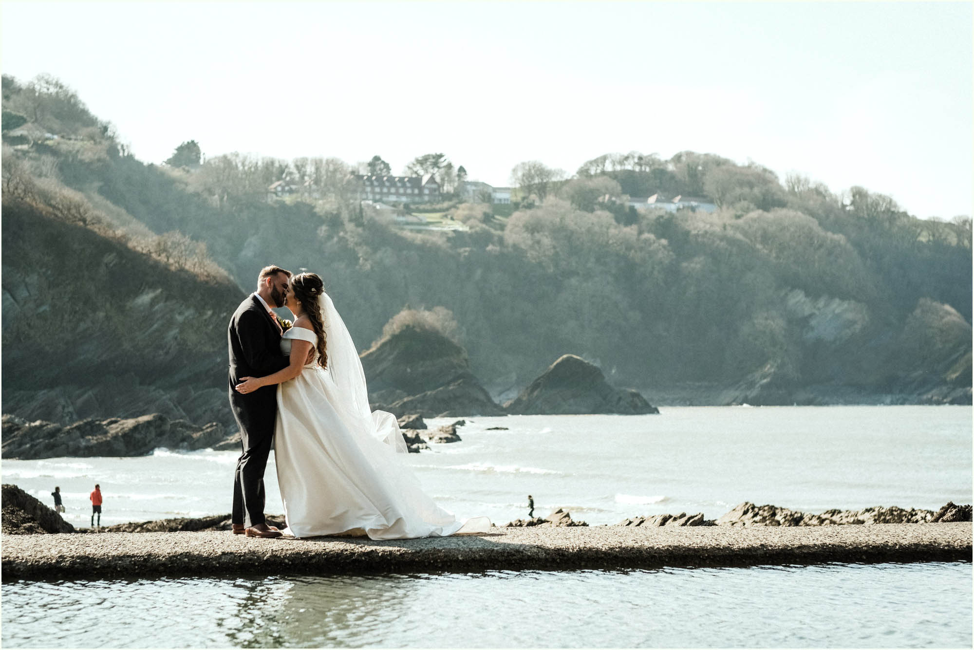 Adam and Abbie's Sandy Cove wedding in Devon with an outdoor ceremony and elegant summer styling in ivory and blush