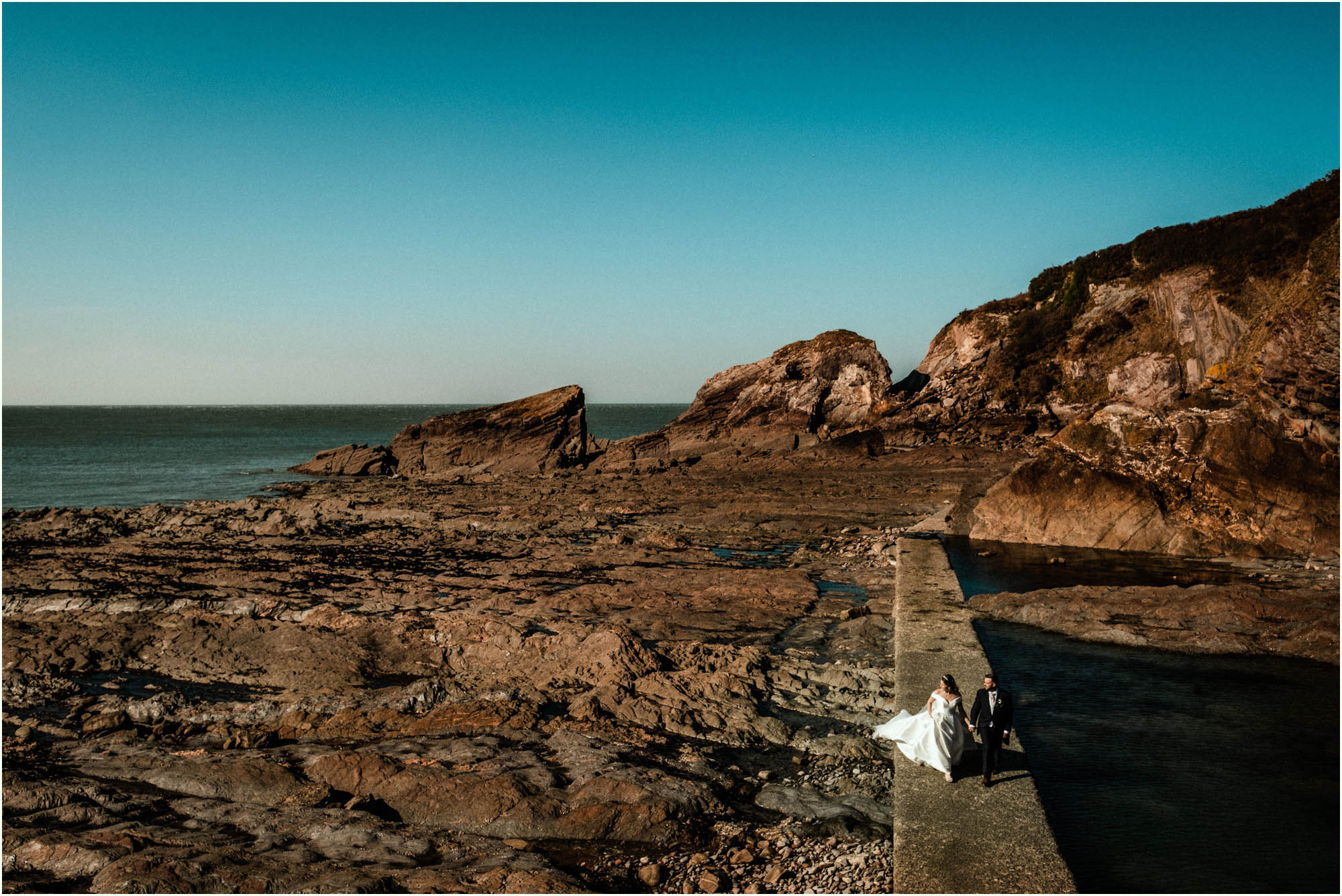 Adam and Abbie's Sandy Cove wedding in Devon with an outdoor ceremony and elegant summer styling in ivory and blush